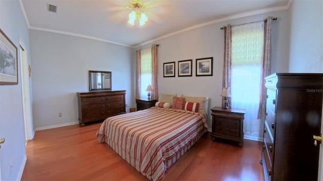 2323 NW 55th Avenue Rd, Ocala, FL 34482 - bedroom with wood finished floors, crown molding, and baseboards