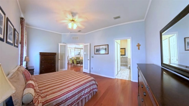 2323 NW 55th Avenue Rd, Ocala, FL 34482 - bedroom with wood finished floors, baseboards, ensuite bathroom, crown molding, and ceiling fan