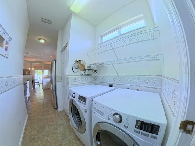 2323 NW 55th Avenue Rd, Ocala, FL 34482 - laundry room with washer and clothes dryer and light tile patterned flooring