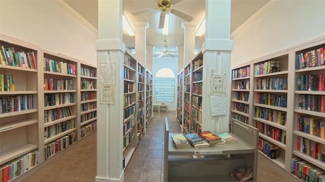 2323 NW 55th Avenue Rd, Ocala, FL 34482 - sitting room with bookshelves, ceiling fan, tile patterned flooring, crown molding, and a towering ceiling