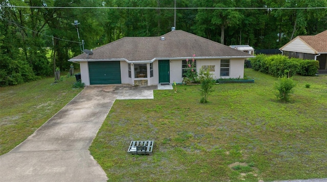 21168 SW Peach Blossom St, Dunnellon, FL 34431 - view of front of home with a front lawn, a garage, stucco siding, a view of trees, and driveway