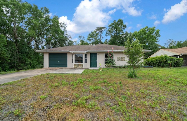 21168 SW Peach Blossom St, Dunnellon, FL 34431 - ranch-style house featuring a garage, stucco siding, driveway, and a front yard