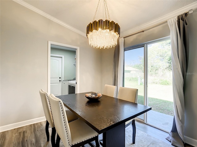 dining area featuring a notable chandelier, baseboards, crown molding, and wood finished floors
