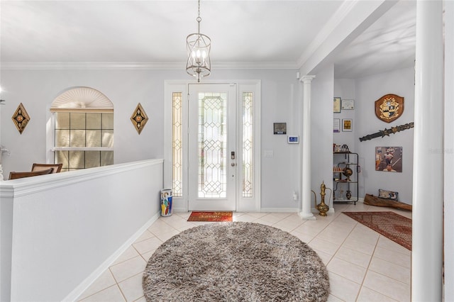 foyer entrance with baseboards, crown molding, ornate columns, and light tile patterned floors
