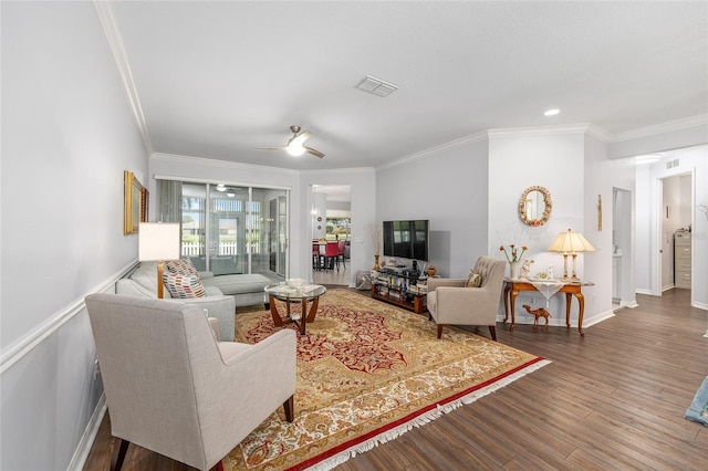 living room featuring baseboards, ornamental molding, and wood finished floors
