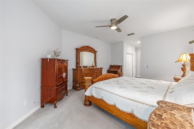 bedroom featuring visible vents, a closet, baseboards, light colored carpet, and ceiling fan