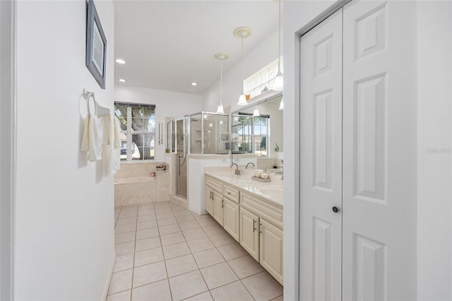 full bath with recessed lighting, tile patterned flooring, double vanity, a sink, and a stall shower