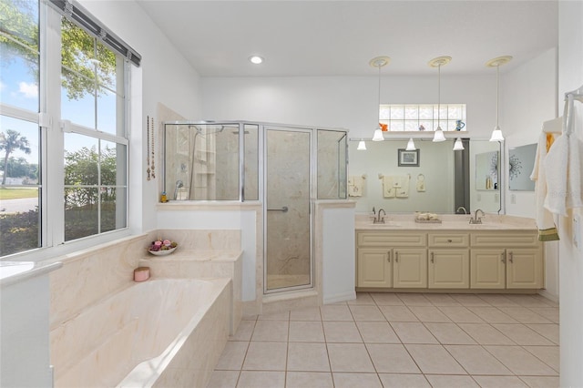 full bath with a wealth of natural light, a sink, tile patterned flooring, and a stall shower