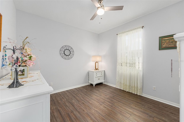 unfurnished bedroom featuring baseboards, dark wood-type flooring, and ceiling fan