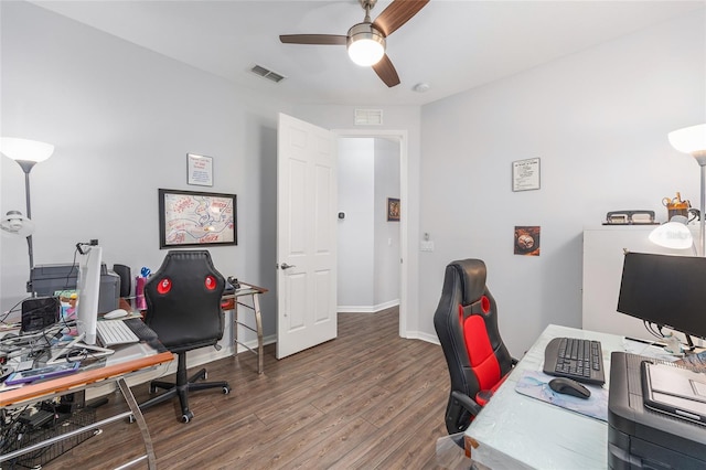 home office with wood finished floors, visible vents, baseboards, and ceiling fan
