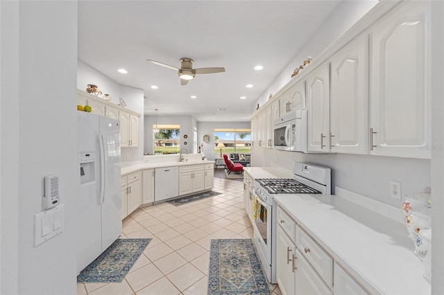 kitchen with white appliances, light tile patterned floors, ceiling fan, a peninsula, and recessed lighting