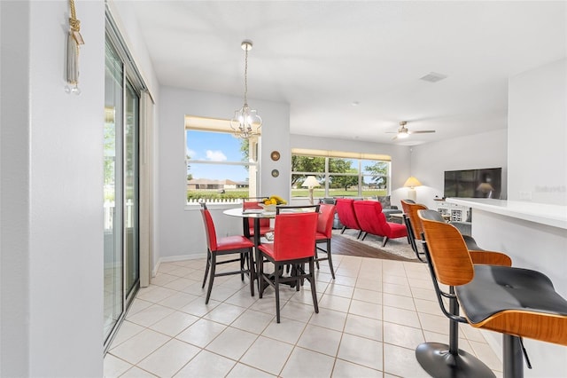 dining area featuring ceiling fan, baseboards, light tile patterned flooring, and visible vents