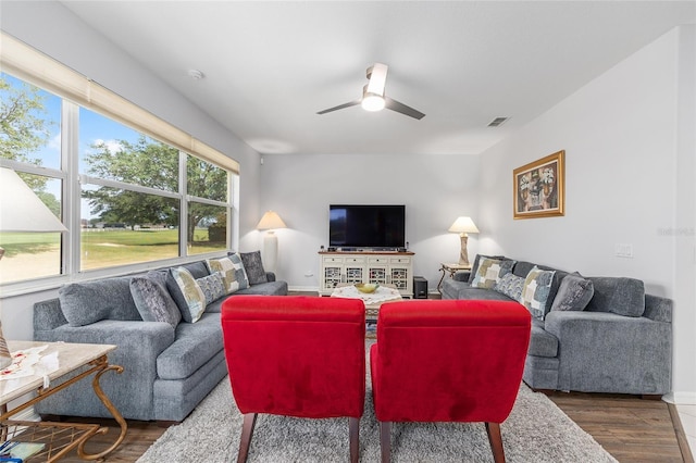 living area with ceiling fan, baseboards, wood finished floors, and visible vents