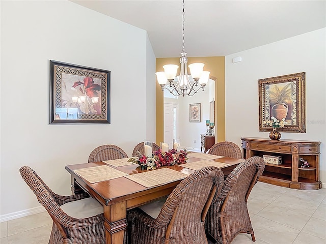 dining space with light tile patterned flooring and a notable chandelier