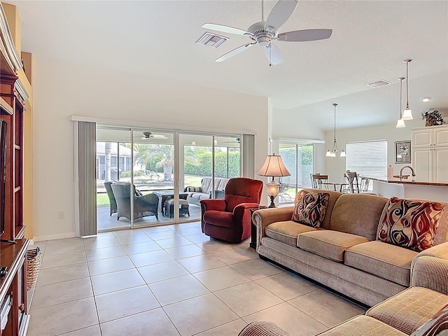 living area with light tile patterned floors, ceiling fan, lofted ceiling, and visible vents