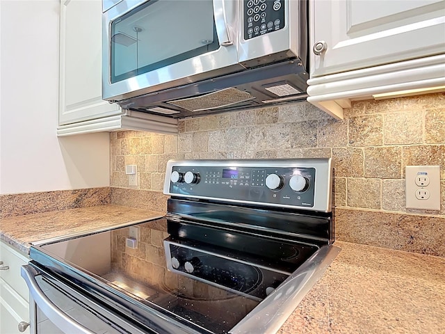 room details featuring range with electric stovetop, decorative backsplash, stainless steel microwave, and white cabinets
