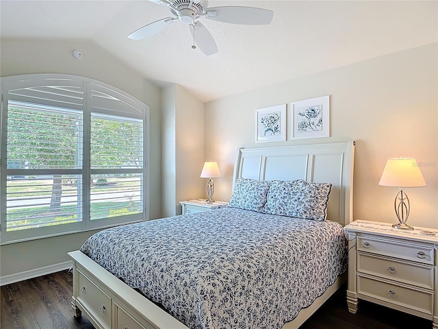 bedroom with ceiling fan, dark wood finished floors, baseboards, and vaulted ceiling