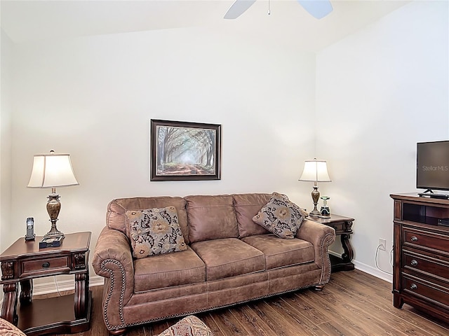 living area with baseboards, a ceiling fan, and wood finished floors