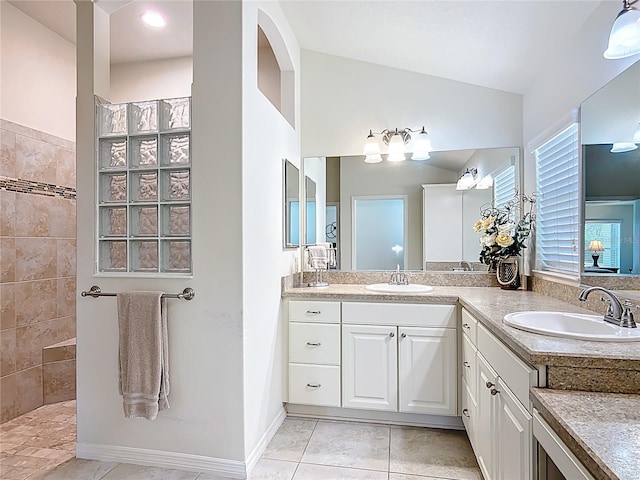 bathroom featuring vanity, tile patterned floors, and walk in shower