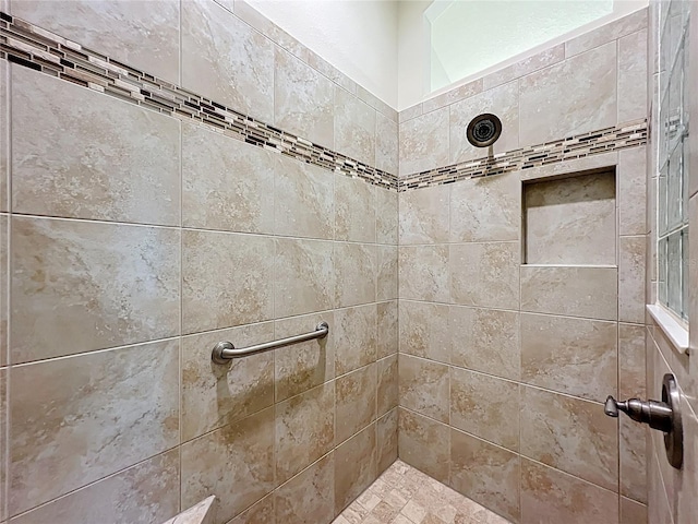 full bath with a tile shower