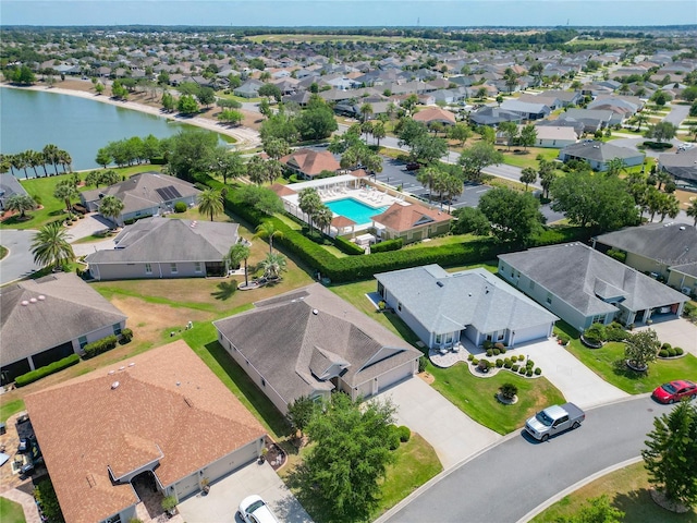 drone / aerial view featuring a residential view and a water view