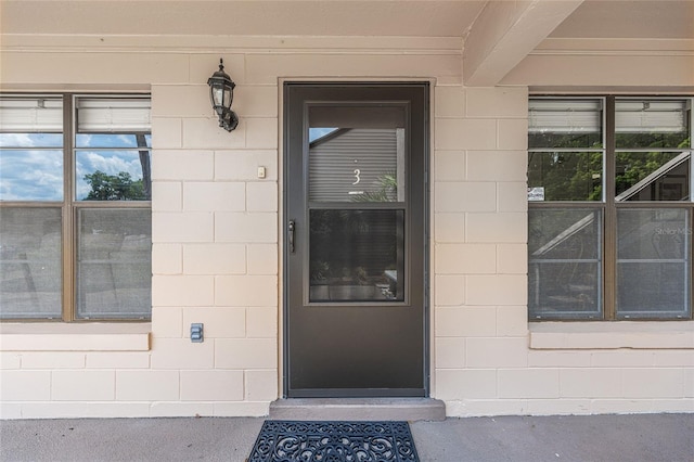 view of exterior entry with concrete block siding