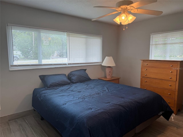 21570 SW Raintree St, Dunnellon, FL 34431 - bedroom with a ceiling fan, wood finished floors, and multiple windows