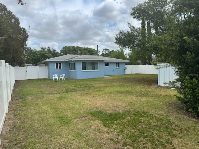 21570 SW Raintree St, Dunnellon, FL 34431 - view of yard featuring a fenced backyard, a storage unit, a gate, and an outbuilding