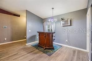 42 Dogwood Drive Crse, Ocala, FL 34472 - unfurnished dining area featuring baseboards, wood finished floors, and an inviting chandelier