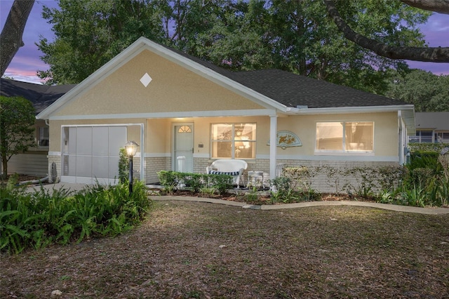 9726 SW 94th Ter Unit C, Ocala, FL 34481 - view of front of house with brick siding, a porch, an attached garage, and stucco siding