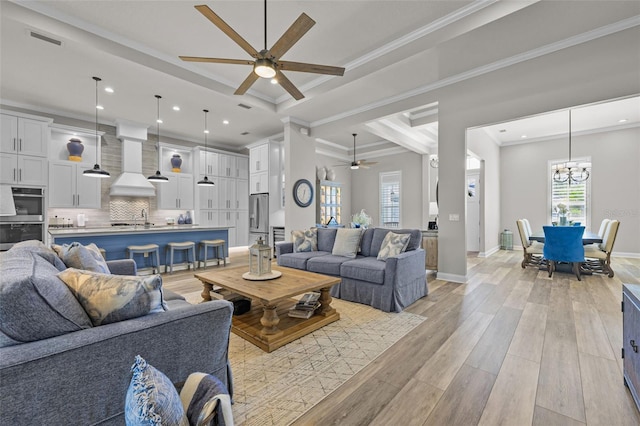 living room with recessed lighting, visible vents, light wood finished floors, and ceiling fan with notable chandelier