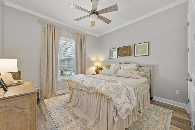 bedroom featuring light wood-type flooring, a ceiling fan, baseboards, and ornamental molding