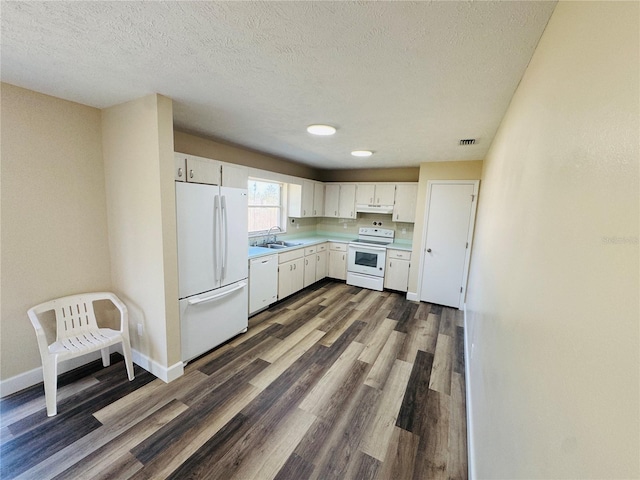 kitchen featuring a sink, white appliances, light countertops, white cabinets, and dark wood finished floors