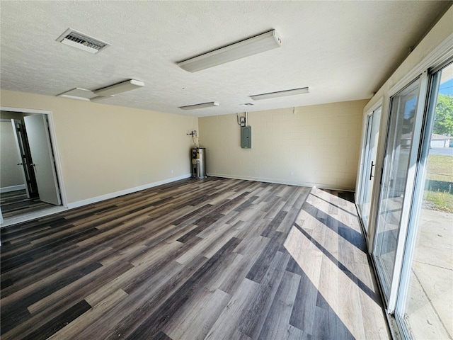 interior space featuring wood finished floors, electric water heater, electric panel, visible vents, and a textured ceiling