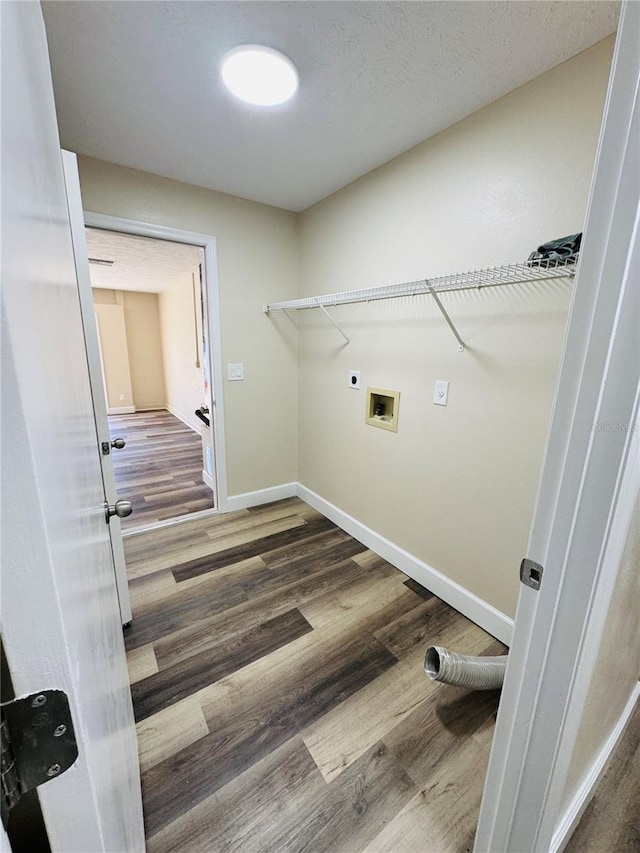 laundry room with washer hookup, laundry area, electric dryer hookup, baseboards, and wood finished floors