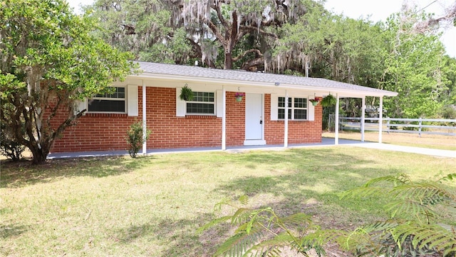 ranch-style house with fence, brick siding, and a front lawn