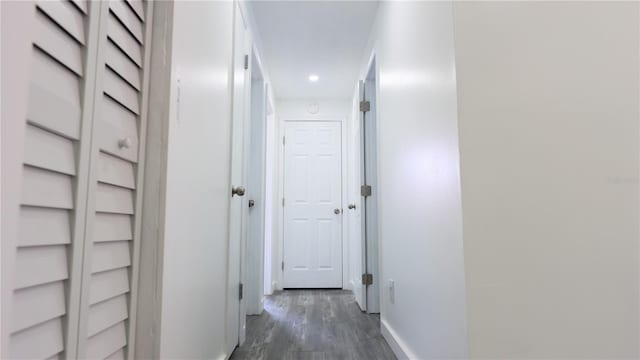 hall featuring recessed lighting, dark wood finished floors, and baseboards