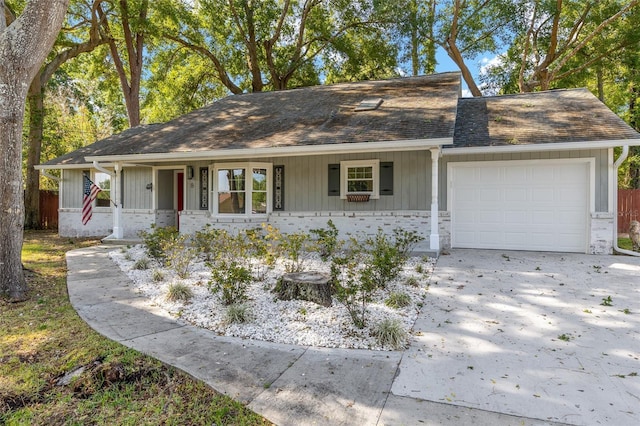 8 Banyan Dr, Ocala, FL 34472 - view of front of home featuring a garage, brick siding, a shingled roof, a porch, and driveway