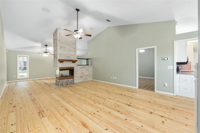 8 Banyan Dr, Ocala, FL 34472 - unfurnished living room with a multi sided fireplace, ceiling fan, wood-type flooring, and high vaulted ceiling