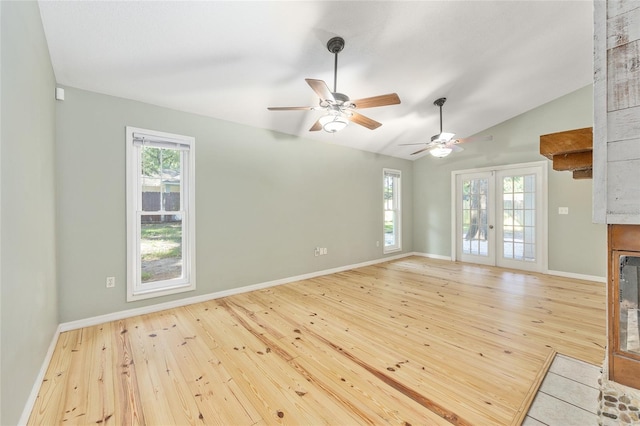 8 Banyan Dr, Ocala, FL 34472 - unfurnished living room with lofted ceiling, baseboards, ceiling fan, hardwood / wood-style flooring, and french doors