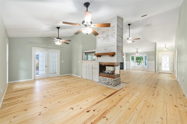 8 Banyan Dr, Ocala, FL 34472 - unfurnished living room featuring a fireplace, a ceiling fan, vaulted ceiling, and hardwood / wood-style floors