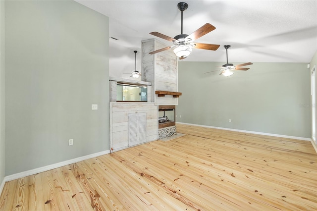 8 Banyan Dr, Ocala, FL 34472 - unfurnished living room with wood finished floors, a fireplace, baseboards, ceiling fan, and high vaulted ceiling