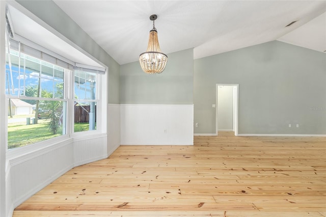 8 Banyan Dr, Ocala, FL 34472 - empty room featuring wood-type flooring, wainscoting, a chandelier, and vaulted ceiling