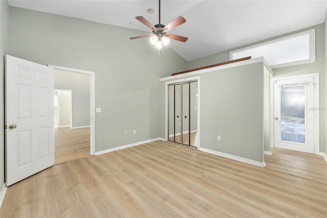 8 Banyan Dr, Ocala, FL 34472 - unfurnished bedroom with baseboards, ceiling fan, light wood-style flooring, and high vaulted ceiling
