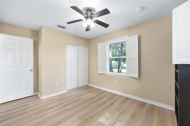 8 Banyan Dr, Ocala, FL 34472 - unfurnished bedroom with baseboards, visible vents, light wood finished floors, and a closet