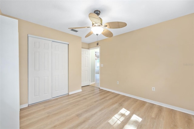 8 Banyan Dr, Ocala, FL 34472 - unfurnished bedroom with ceiling fan, light wood-style flooring, baseboards, visible vents, and a closet