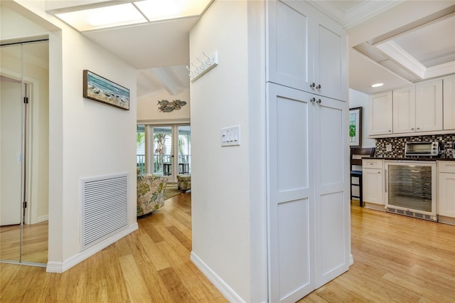 255 NW Bay Path Dr, Crystal River, FL 34428 - corridor featuring visible vents, light wood-type flooring, ornamental molding, and wine cooler