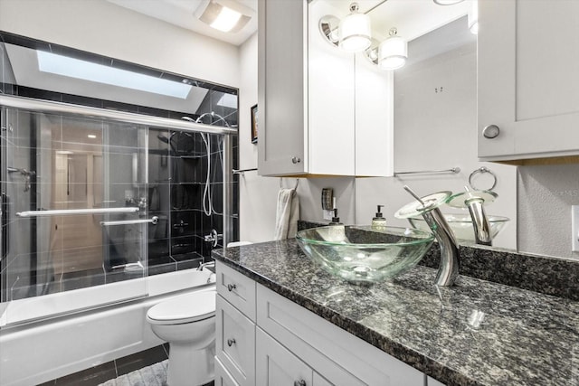 255 NW Bay Path Dr, Crystal River, FL 34428 - bathroom featuring toilet, shower / bath combination with glass door, and vanity