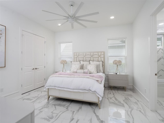 bedroom featuring recessed lighting, marble finish floor, and multiple windows