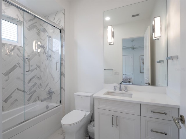 full bathroom featuring vanity, toilet, visible vents, enclosed tub / shower combo, and ensuite bathroom